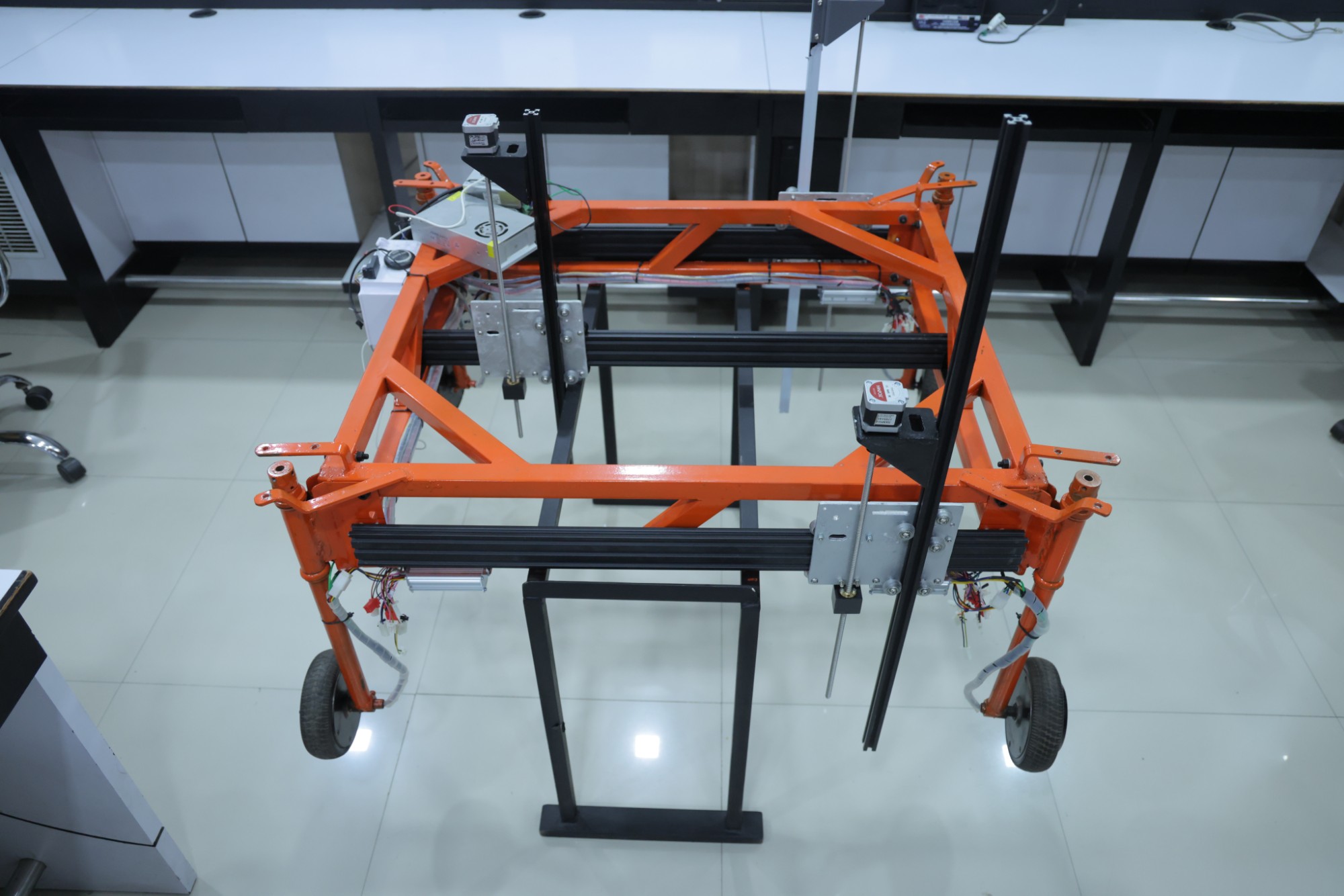 Rover chassis under construction in our lab — drive wheels, linear rails and stepper motors mounted
